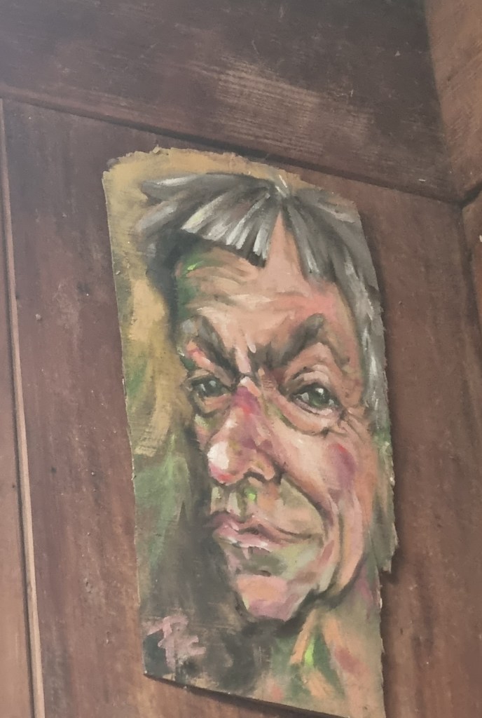 Painting of Potter Barry Brickell, painted on irregular shaped board, mounted on raw wood wall