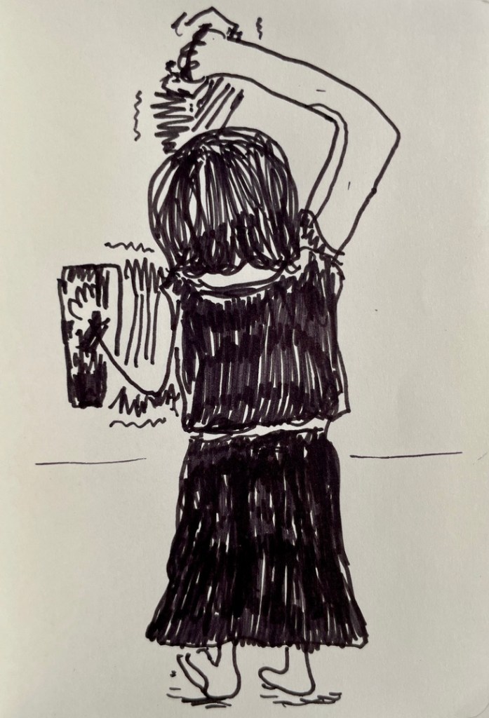 A woman playing an accordion in each hand