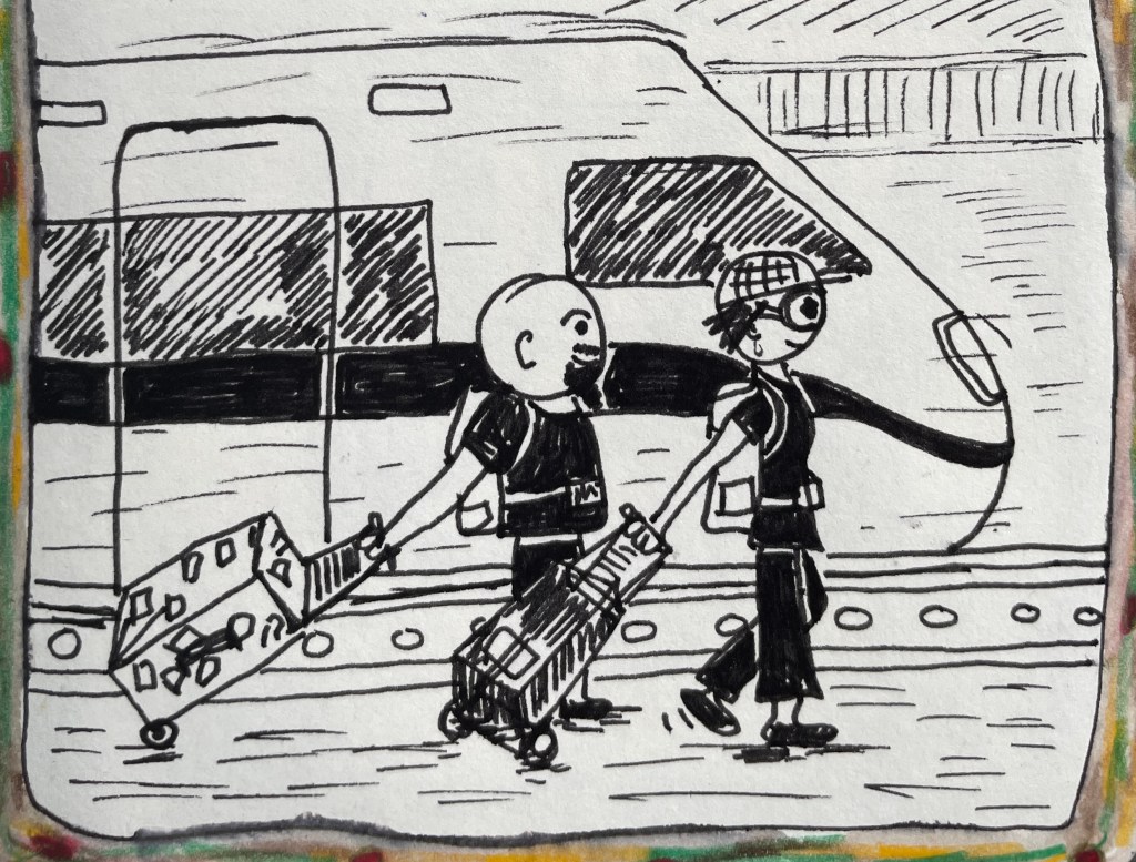 Two people lugging band gear beside a train