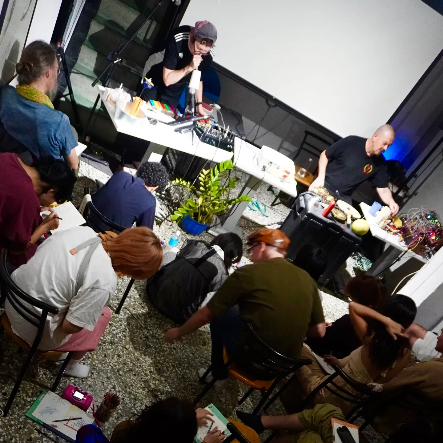 Audience drawing sketches during a performance