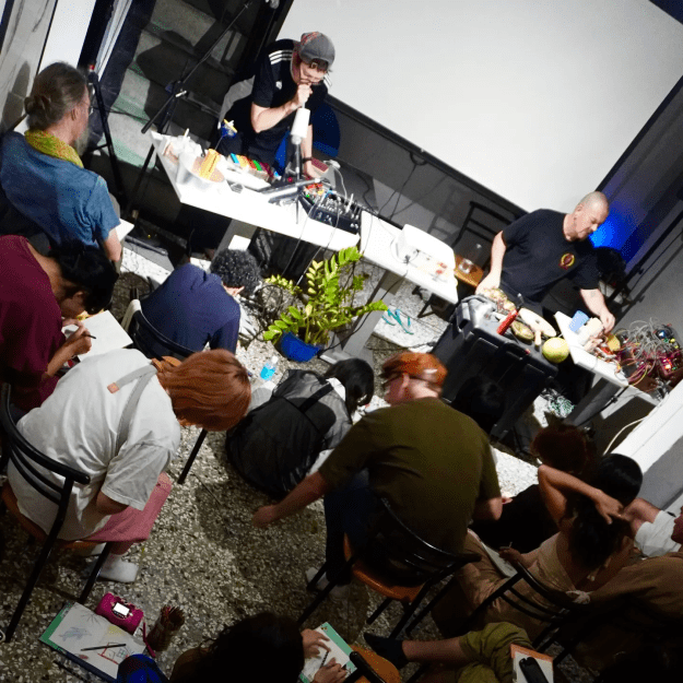 Audience drawing sketches during a performance